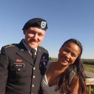 a USAF airman in uniform with his spouse