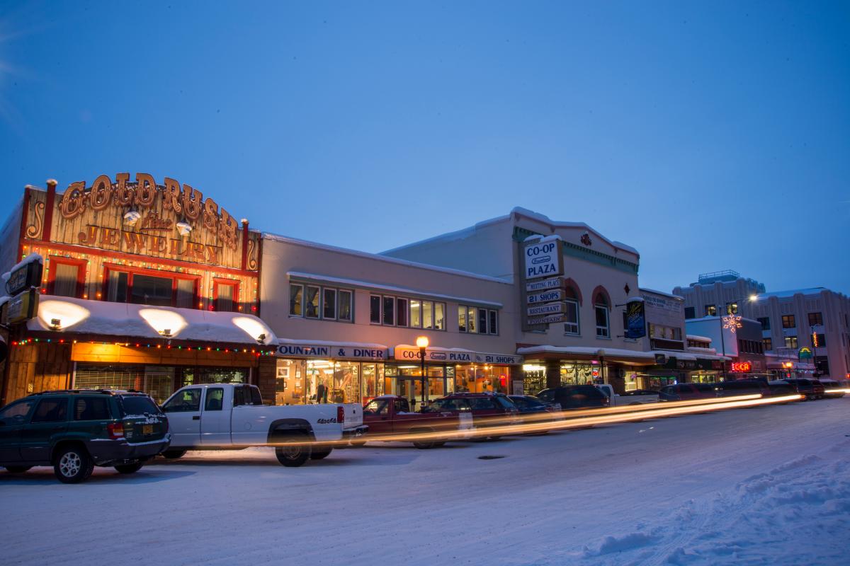 Downtown Fairbanks in winter, decorated with holiday lights. Snow on the ground.