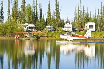 Floatplane with RVs and trees in background